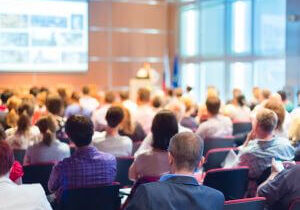 Audience seated in a bright conference hall